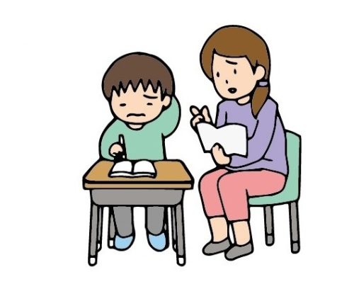 子供に個別支援をする教師