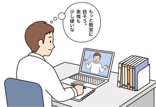 パソコンで自分の授業の録画を見て、振り返りをする男性教師